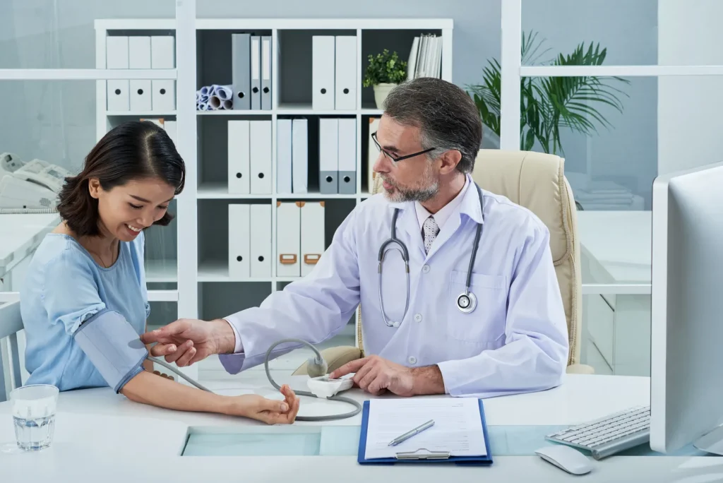 Doctor checking a patient’s blood pressure