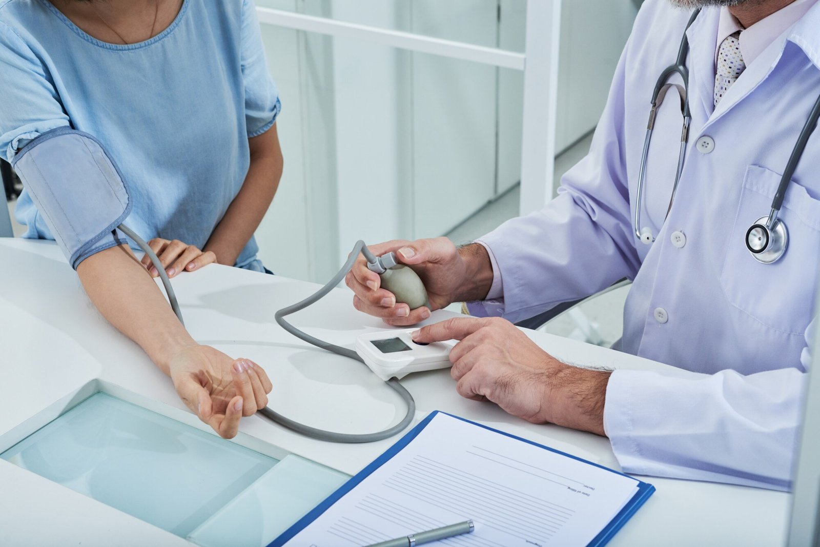 Doctor checking a patient’s blood pressure