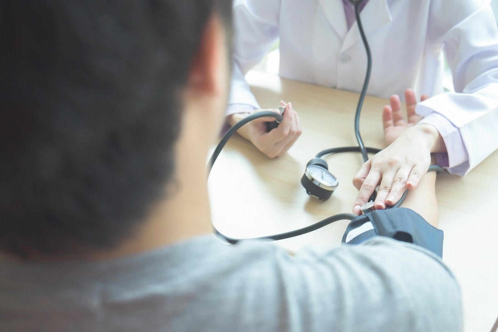 Doctor checking a patient’s blood pressure